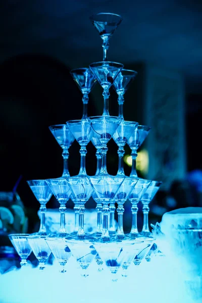 Group of Martini glasses with bright blue illumination — Stock Photo, Image