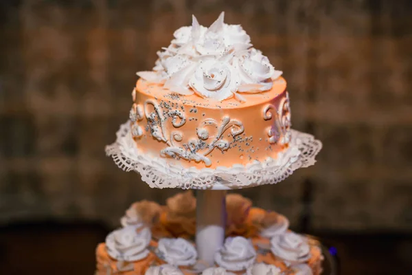 Wedding cake orange with white flowers of cream — Stock Photo, Image