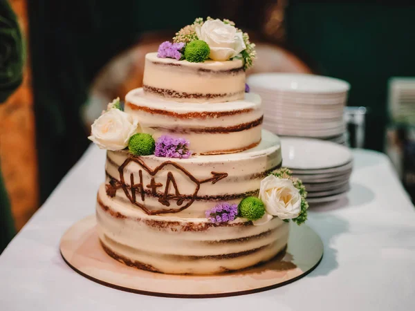 sweet wedding cake with tiers decorated with flowers