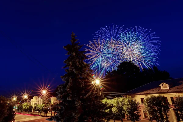 Destellos multicolores de fuegos artificiales sobre la ciudad en celebración — Foto de Stock