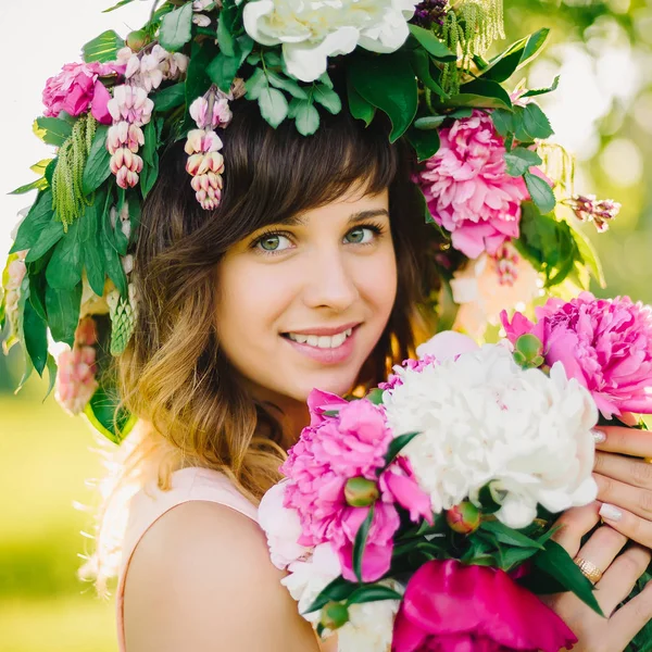 çiçek çelenk ve peonies gün güneşli yaz bir buket ile mutlu gülümseyen kız