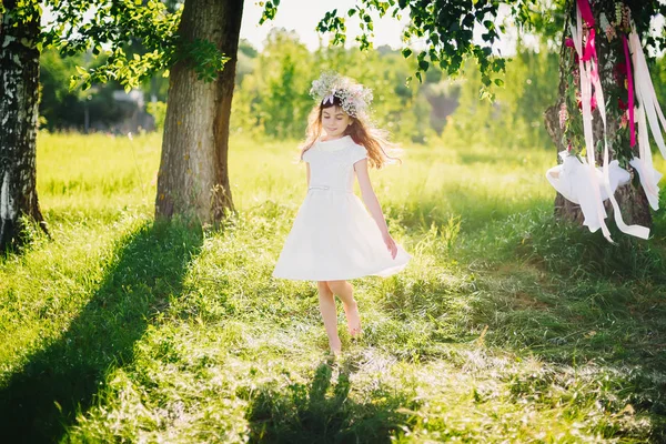 Young girl happily spinning in the meadow in nature on a summer day — Stock Photo, Image