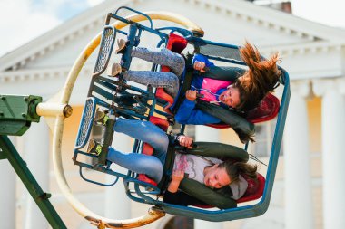 Vichuga, Rusya Federasyonu - 24 Haziran 2017: İki kız parkta bir atlıkarınca Vichuga gün üzerinde binmek.