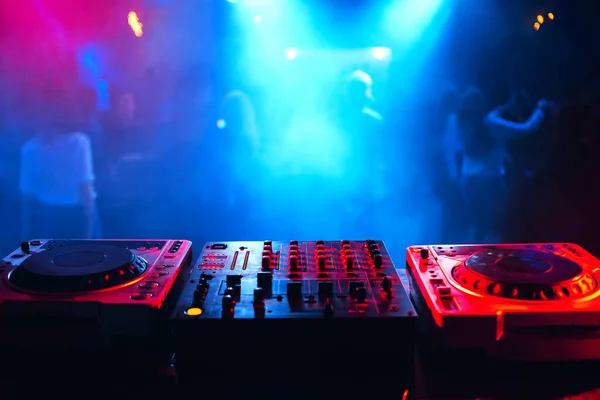 Soundboard DJ console in the booth for mixing electronic music at a party Stock Photo