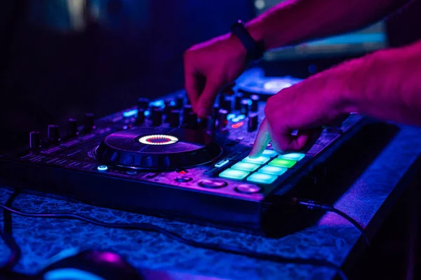 Hands of a DJ playing music on a mixer at a concert — Stock Photo, Image