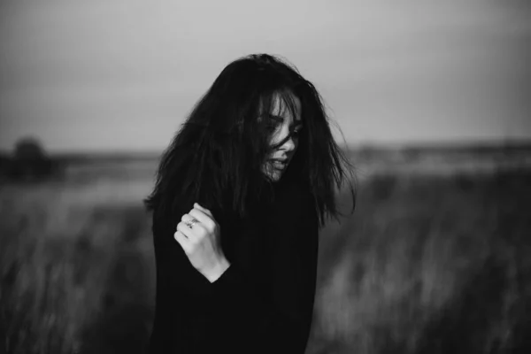 Black and white portrait of a young girl posing Caucasian brunette girl in a sweater — Stock Photo, Image