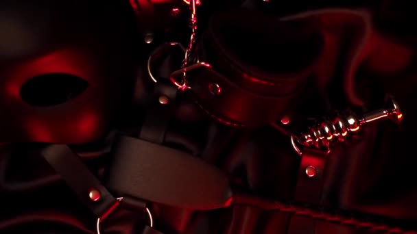 Leather whip, handcuffs, mask and metal anal plug for BDSM sex — Stock Video
