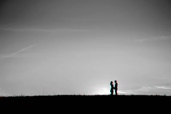 Silhouette of a couple in love hugging together — Stock Photo, Image