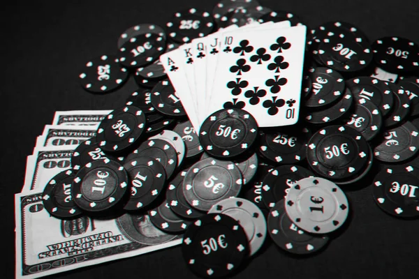 cards with a Royal flush on a pile of chips and money dollars in a game of poker