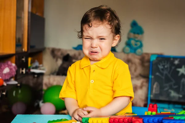 Sad baby boy crying next to toys — Stock Photo, Image