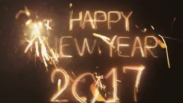 Happy New Year 2017 inscription sparklers on a black background . — Stock Video