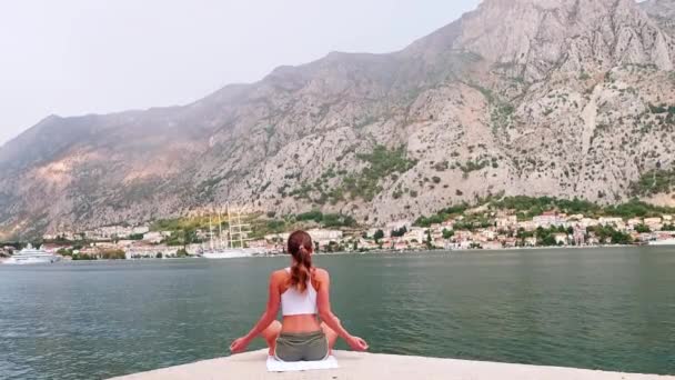 Beau yoga avec vue imprenable sur la mer en arrière-plan, jolie femme en bonne santé avec un corps parfait debout dans une pose de yoga — Video