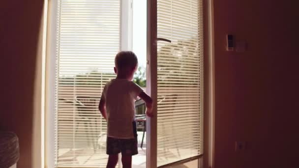 Beautiful little boy open the window rural house — Stock Video