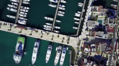 Havadan görünümü üzerinde yat kulübü. Mavi deniz suyu beyaz tekneler vardır.