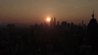 Kuala Lumpur şehrinin silüetiyle sabah dramatik ve turuncu hava manzaralı Kuala Lumpur şehri