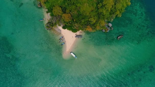 AERIALNE. Widok z góry zielonej wyspy i plaży z tradycyjnej tajskiej łodzi o zachodzie słońca. — Wideo stockowe