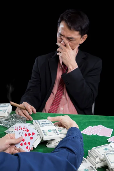 The male gambler uses hand off the face with stressed when conte