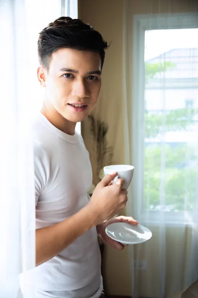 young man drink coffee at home