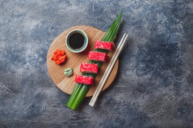 Suşi tahtada yuvarlanıyor. Taş zemin. Üst görünüm