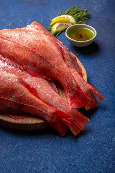 Fresh red sea bass on blue background. Top view, copy space — Stock Photo, Image