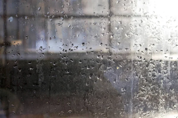 Druppels smeltwater op een glazen oppervlak — Stockfoto