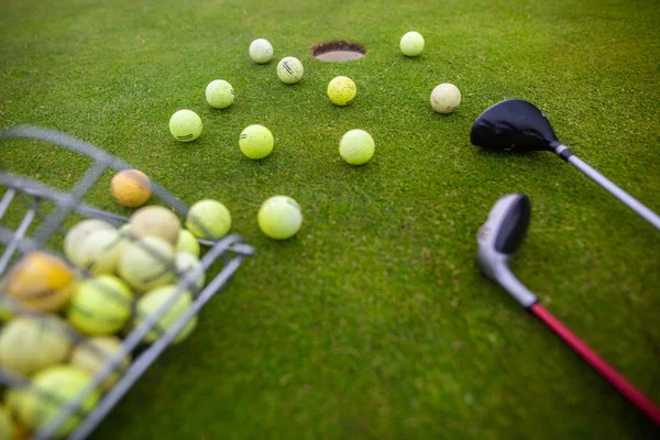 Equipo profesional del golf en un césped hermoso, aseado, algunas pelotas y dos palos del golf, concepto del deporte —  Fotos de Stock