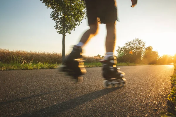 stock image Man roller skating on the cycle path during lovely summer sunset, sport concept, motion blurred image