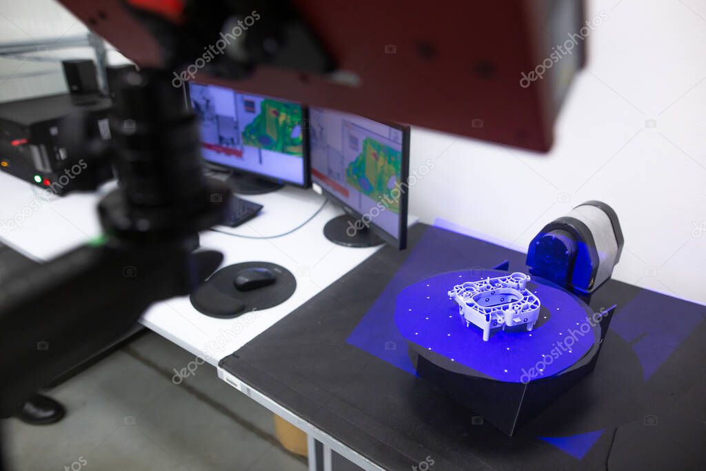 Professional 3D scanner scanning an industrial object plastic molding placed on a turntable, metrology concept