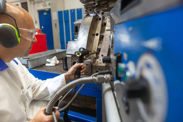 Engineer doing maintenance on a injection mold for plastic components, industrial and automotive concept — Stock Photo, Image