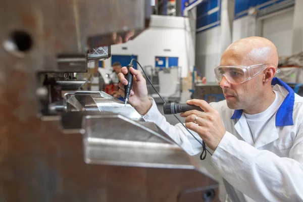 Engineer doing maintenance on a injection mold for plastic components, industrial and automotive concept — Stock Photo, Image