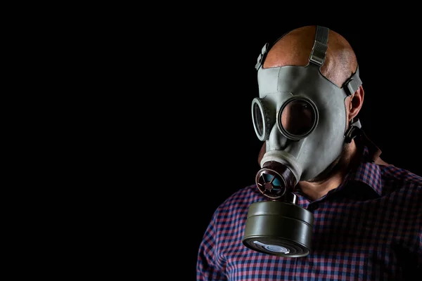 Close up of man wearing gas mask against coronavirus, covid 2019 on a black background, healthcare concept — 스톡 사진