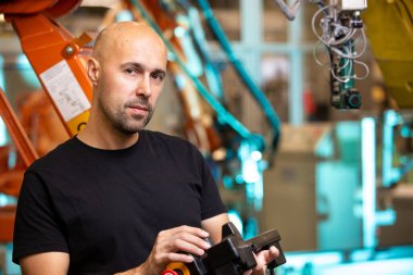 Endüstriyel akıllı fabrikadaki memnun çalışanın portresi, ekonomik kriz ve sanayi konsepti nedeniyle yeni eleman alımı