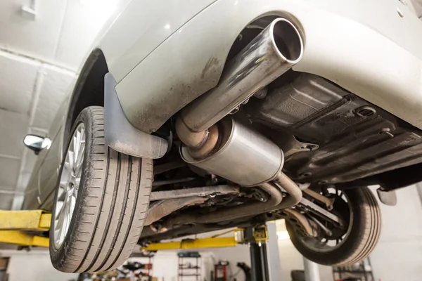 Close up of car exhaust system pipe at the garage, automotive car service — Stock Photo, Image