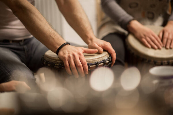 Close up of hands on african drums, drumming for a music therapy, therapy by drums