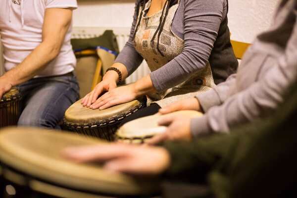 Close up of hands on african drums, drumming for a music therapy, therapy by drums