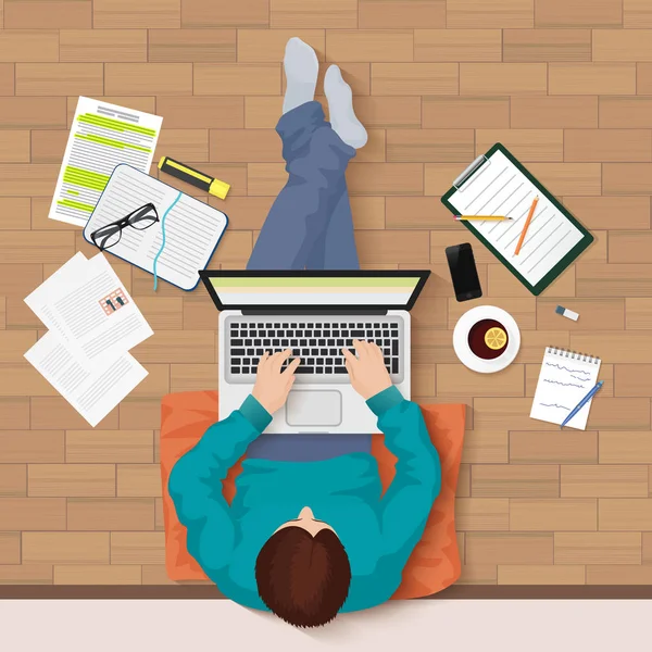 Vektör en iyi manzara laptop ve öğeleri çalışma alanı ile katta oturan genç adam. Office, Üniversite Kütüphanesi.