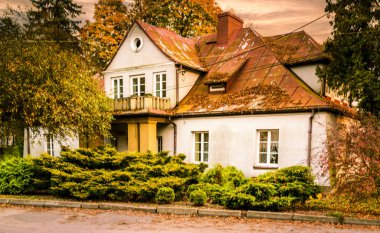 Historic palace surrounded by autumn park, central Poland.