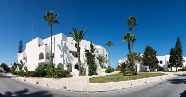 White building, palm trees. Tunisia, travel. Panorama.