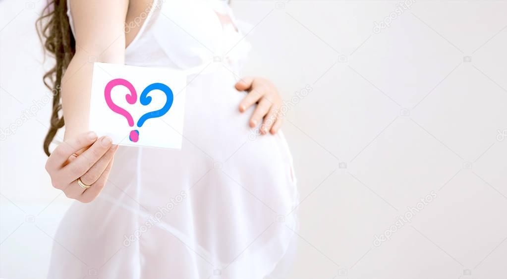 Pregnant woman belly holding  ultrasound scan of baby. Healthy pregnancy. Newborn baby booties in parents hands. Concept of Pregnancy health care. Boy or girl