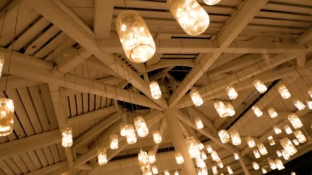Self Made Lanterns From Cans Are Suspended On A Wooden Ceiling And