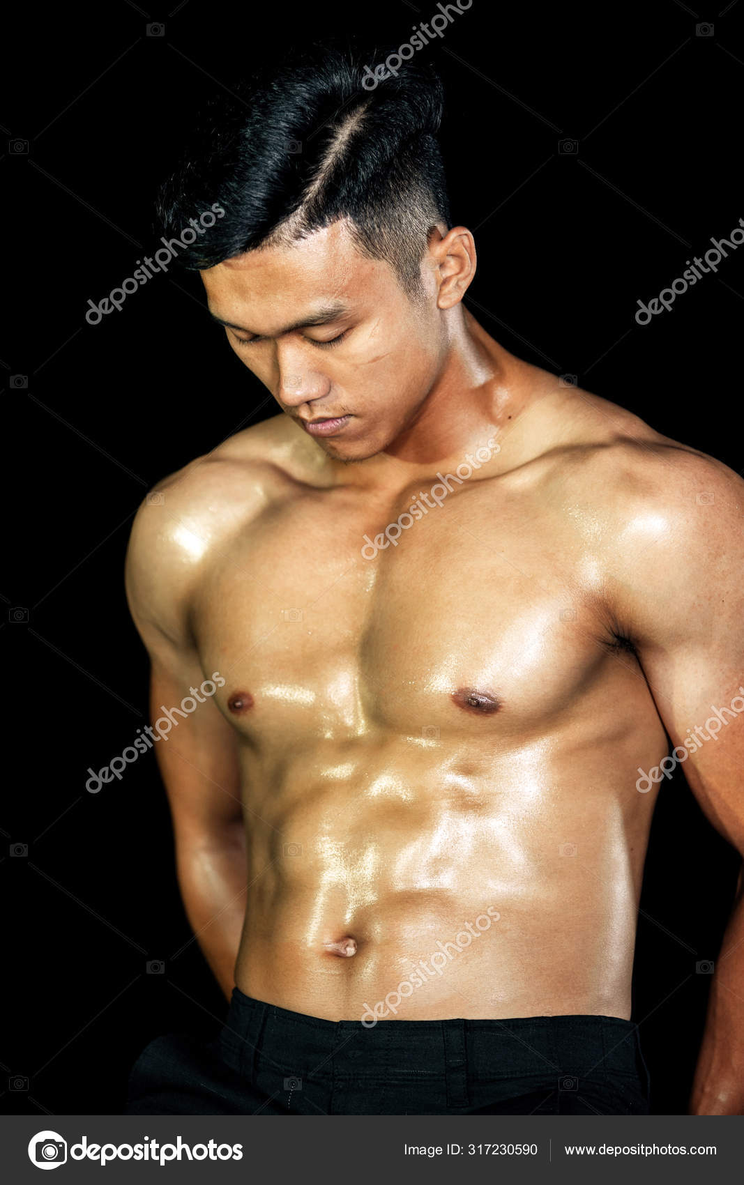 Asian bodybuilder handsome men posing muscle front on the black background.  Fitness body gym big chest and shoulder and bicep. Healthy ideal body type.  Stock Photo by ©khoamartin 317230590