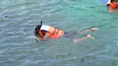 People swimming on the ocean with life jacket. Enjoy summer vacation on the beach. Sunday 10 April 2019, Phu Quoc, Vietnam