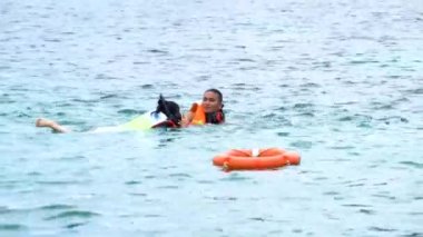 People swimming on the ocean with life jacket. Enjoy summer vacation on the beach. Sunday 10 April 2019, Phu Quoc, Vietnam