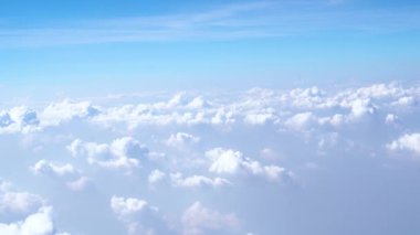 Beautiful white clouds floating in the air in the blue sky in the morning through airplane view