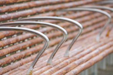 Parkta demir saplı ahşap sandalye, yakın çekim. Seçici odak.