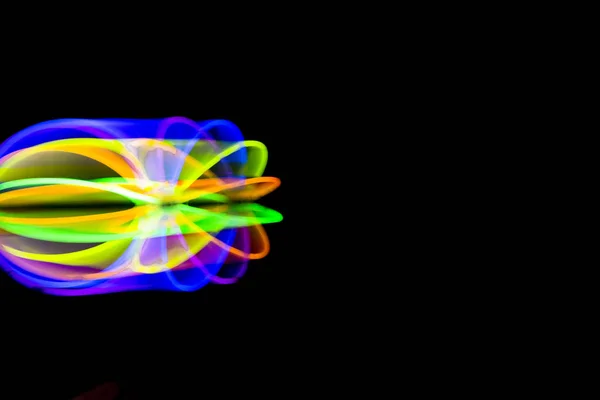 Blur Ball in motion made with glow sticks fluorescent lights