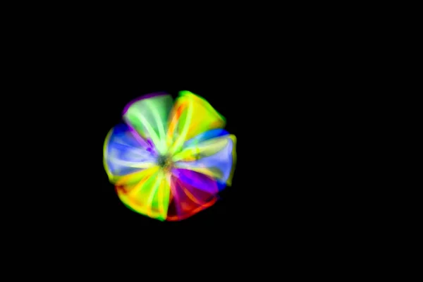 Blur Ball in motion made with glow sticks fluorescent lights
