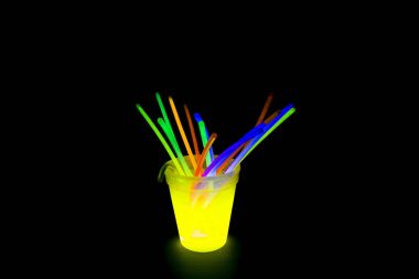 Yellow colored fluorescent glass with glow sticks lights clipart