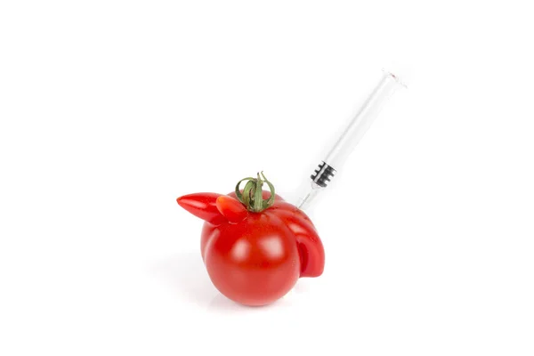 Tomatoes with deformation and defects on white background, with syringe. — Stock Photo, Image