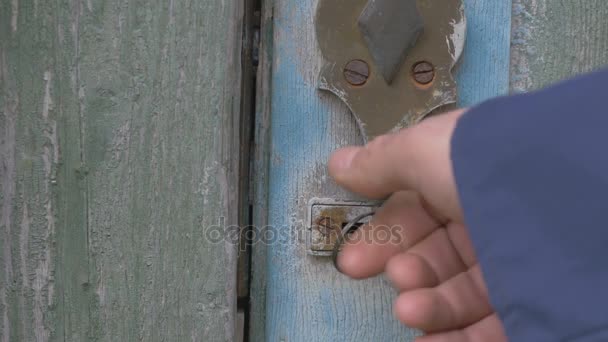 The boss man unlocks the door, metal lock and enters the room of the barn, 4K — Stock Video